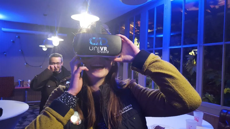 Une participante ajuste son casque VR dans une salle éclairée en bleu.